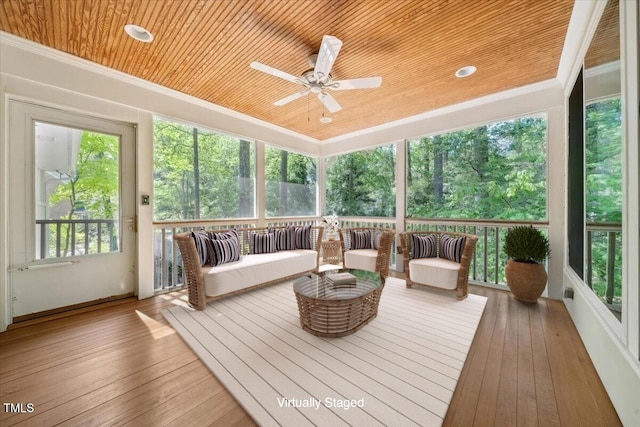 sunroom / solarium featuring ceiling fan and an outdoor hangout area