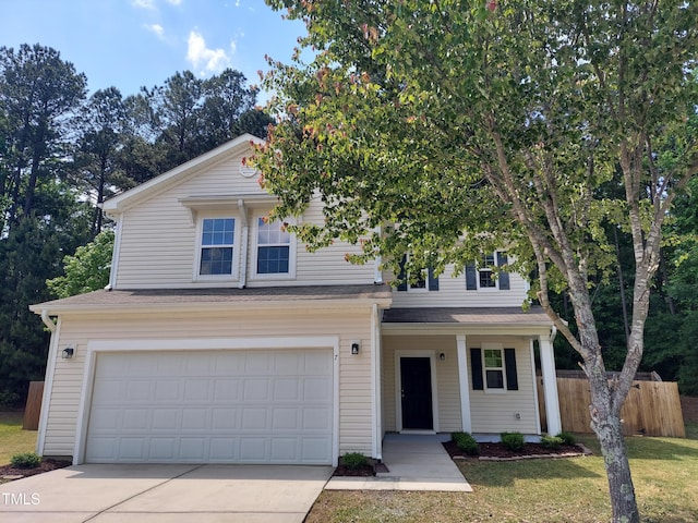 traditional home with a porch, a garage, fence, a front lawn, and concrete driveway
