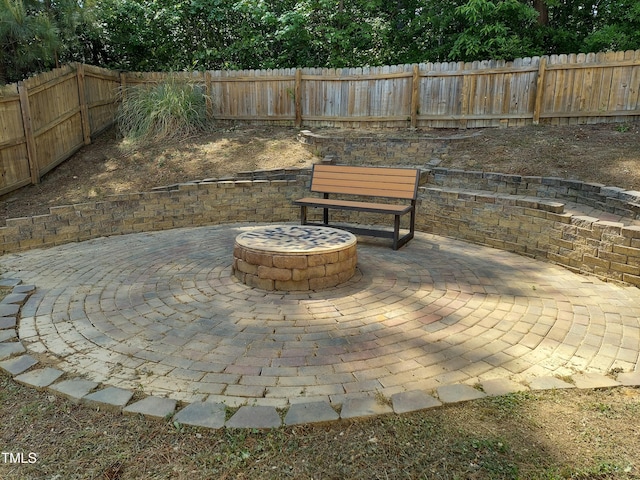 view of patio / terrace with a fenced backyard and an outdoor fire pit