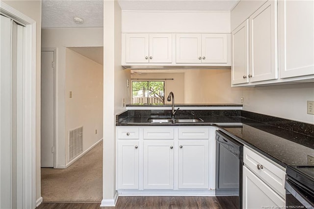 kitchen featuring visible vents, dark wood-style floors, white cabinetry, a sink, and dishwasher