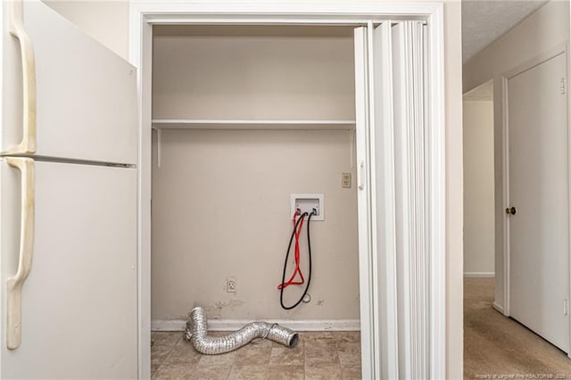 clothes washing area featuring baseboards, laundry area, and washer hookup