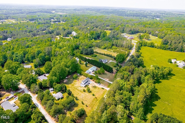 birds eye view of property with a view of trees