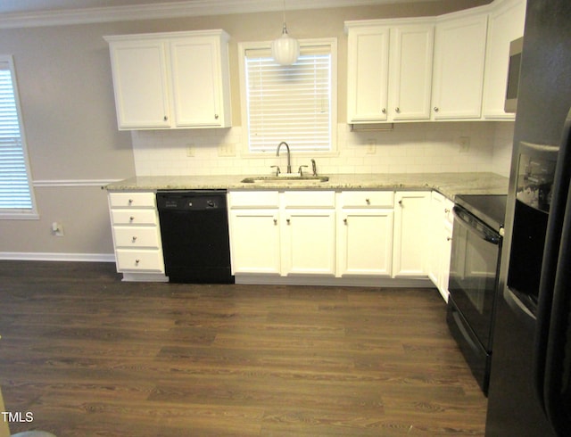 kitchen featuring a sink, crown molding, backsplash, and black appliances