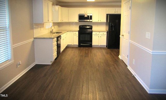 kitchen featuring a sink, decorative backsplash, black appliances, and dark wood-style flooring