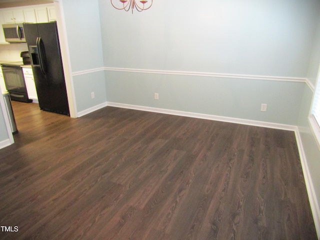 unfurnished dining area with baseboards and dark wood-style flooring
