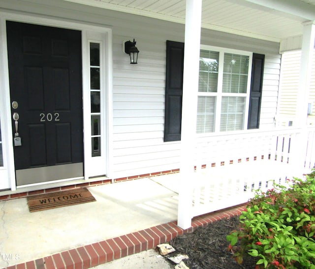 view of exterior entry with covered porch