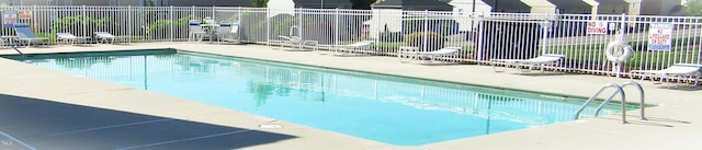 community pool featuring a patio area and fence