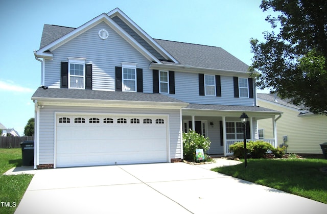 202 Redstone Ct, Gibsonville, NC 27249 - view of front of home with covered porch, concrete driveway, an attached garage, and a shingled roof