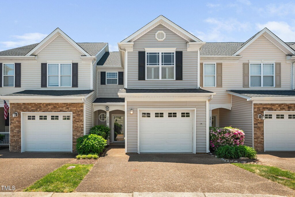 2609 Asher View Ct, Raleigh, NC 27606 - view of property with an attached garage, driveway, and a shingled roof