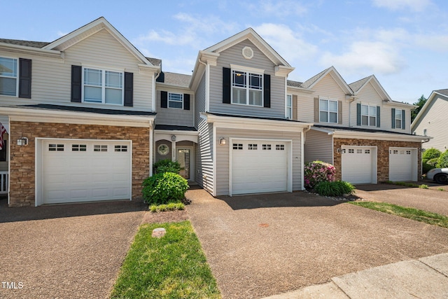view of property with driveway and a garage