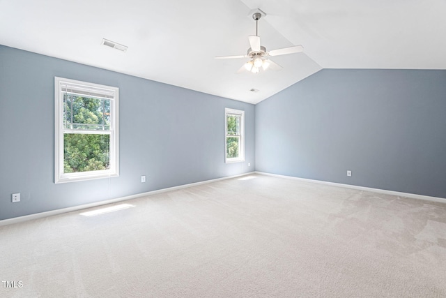 unfurnished room with visible vents, carpet flooring, ceiling fan, and vaulted ceiling