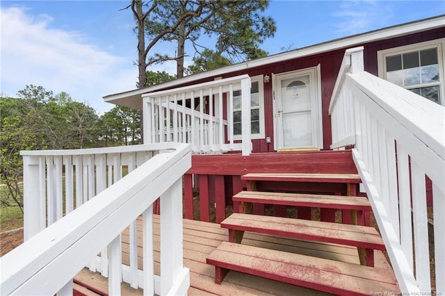 view of exterior entry with a deck