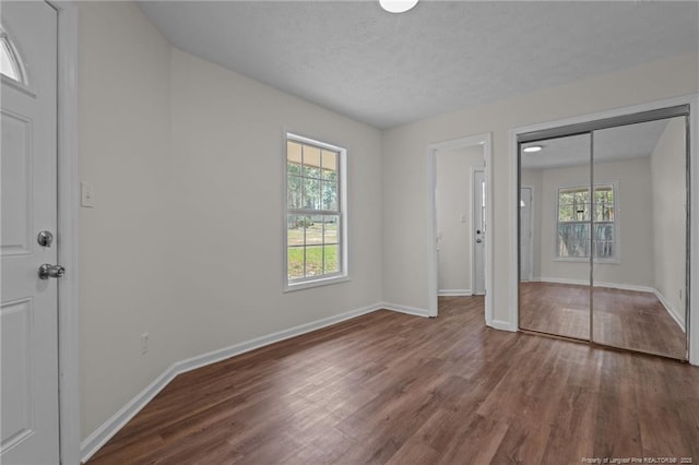 unfurnished bedroom featuring baseboards and wood finished floors