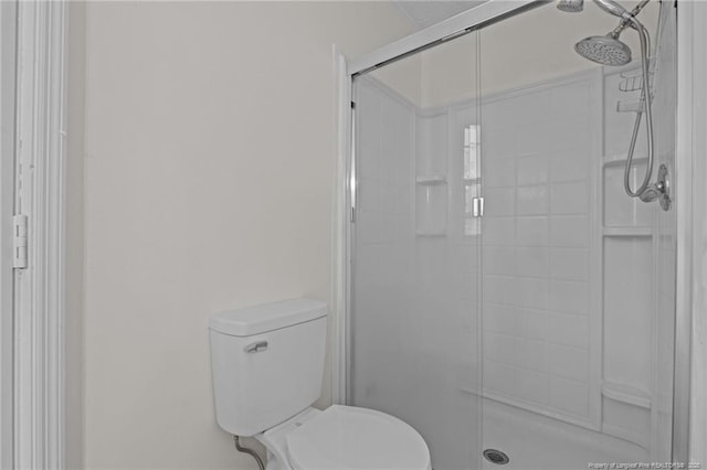 bathroom featuring a shower stall and toilet