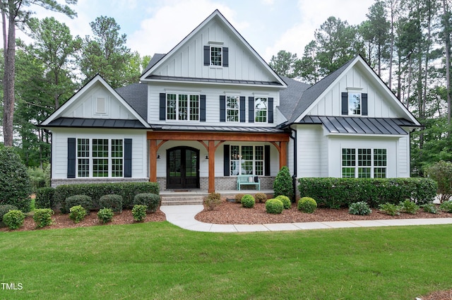 view of front of house featuring board and batten siding, covered porch, and a standing seam roof