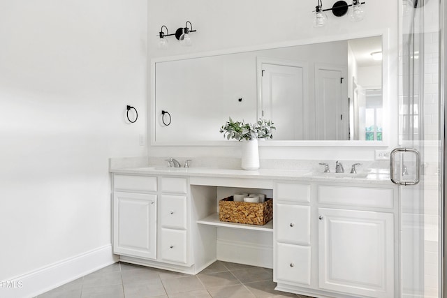 bathroom with double vanity, a sink, and tile patterned floors