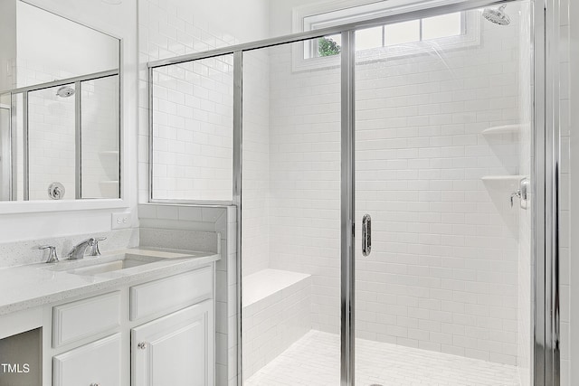 bathroom with vanity and a shower stall