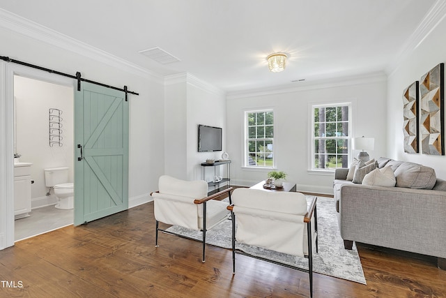 living area with crown molding, a barn door, baseboards, and dark wood-type flooring