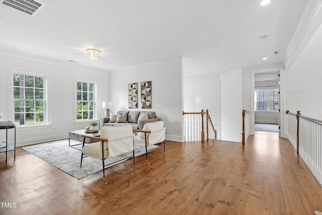 living room with crown molding, plenty of natural light, recessed lighting, and visible vents