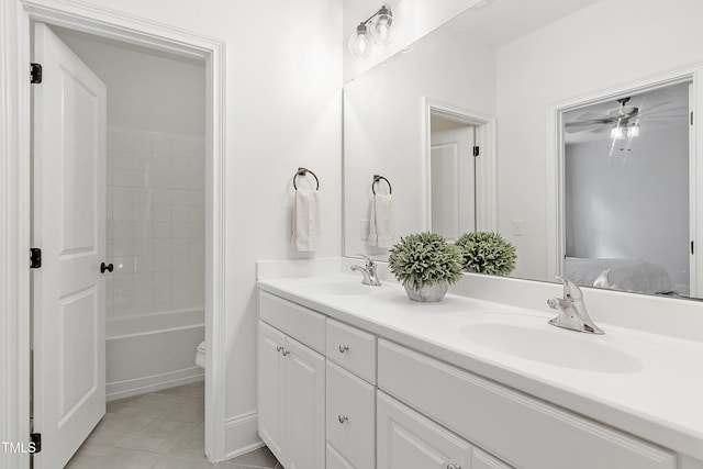 bathroom with double vanity, tile patterned floors, ceiling fan, and a sink