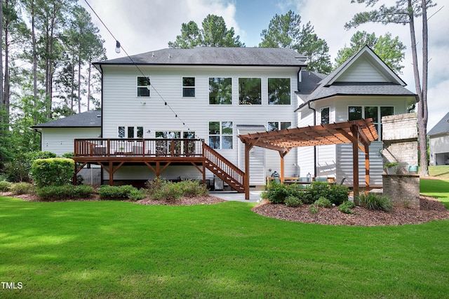 rear view of property featuring a lawn, a pergola, a shingled roof, and a deck