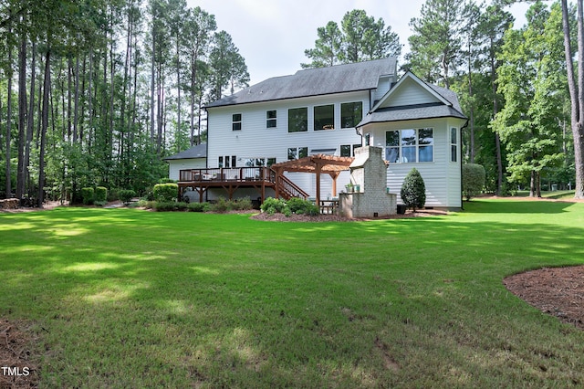 back of house featuring a lawn, a pergola, a shingled roof, and a wooden deck