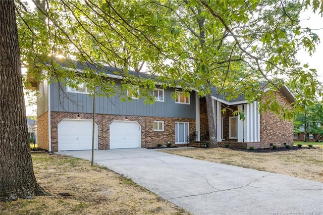 view of front of house featuring brick siding, a garage, and driveway