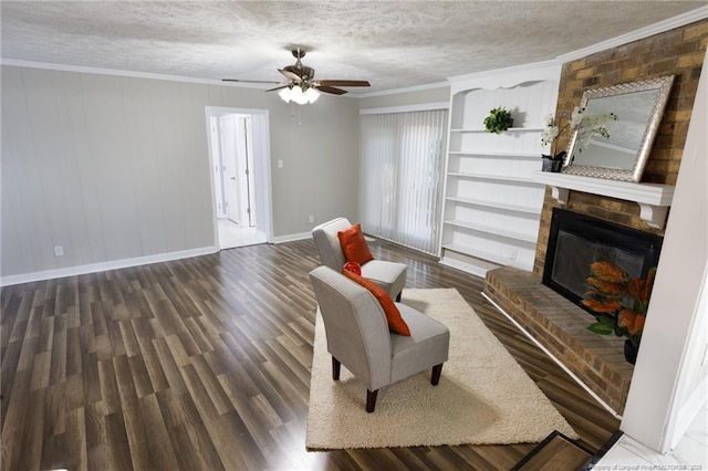 living room featuring baseboards, ceiling fan, a textured ceiling, and wood finished floors