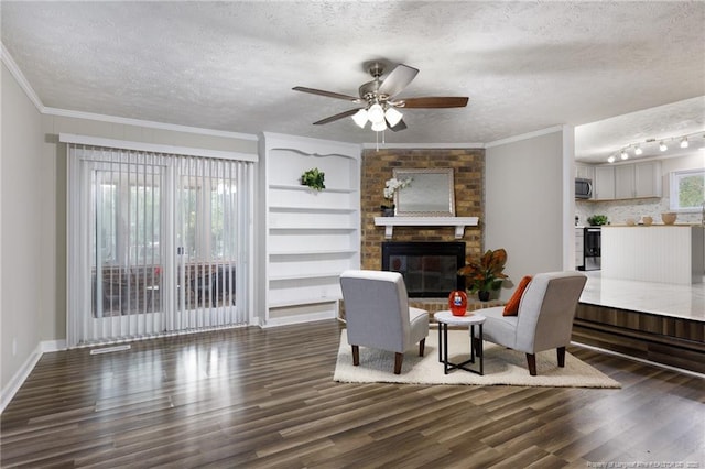 living room with a textured ceiling, ceiling fan, and wood finished floors