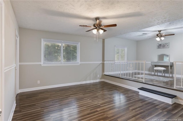 spare room with a textured ceiling, ceiling fan, and wood finished floors