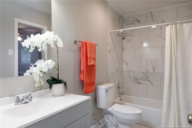 bathroom with vanity, ceiling fan, toilet, and shower / bath combination with curtain