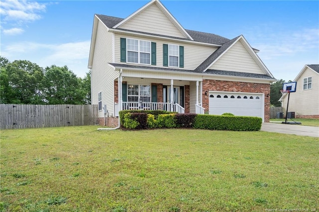 traditional-style house featuring fence, an attached garage, a porch, a front yard, and driveway