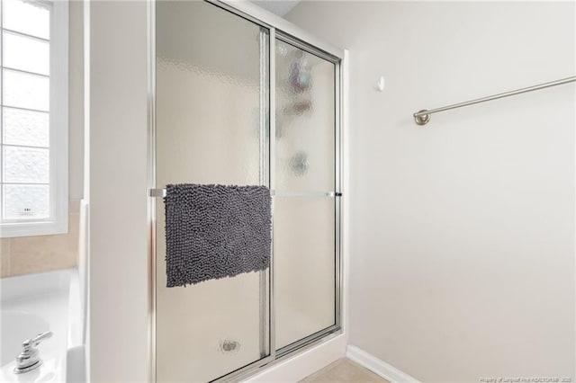 bathroom with a bath and a shower stall