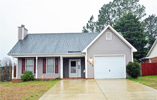 view of front of home with an attached garage, a shingled roof, fence, and driveway