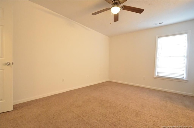 empty room with baseboards and light carpet