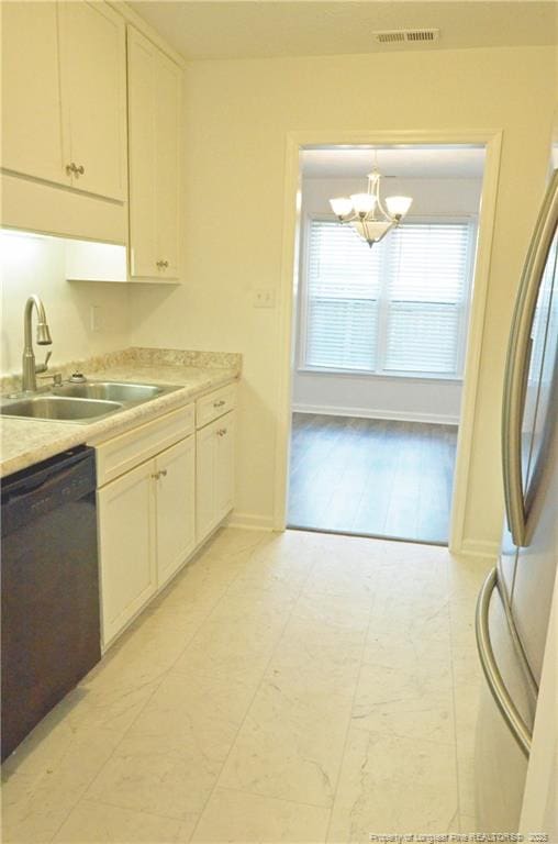 kitchen featuring visible vents, a sink, light countertops, white cabinets, and black dishwasher