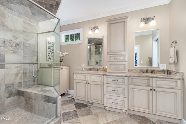 bathroom with a sink, ornamental molding, a shower stall, and double vanity