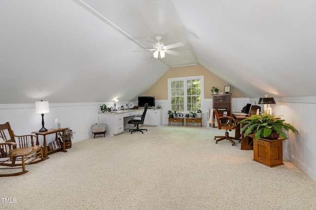 office area with ceiling fan, a decorative wall, carpet floors, a wainscoted wall, and lofted ceiling