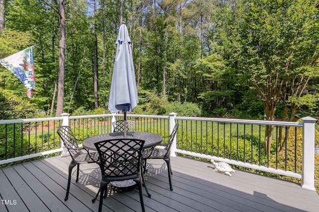 wooden terrace featuring outdoor dining space