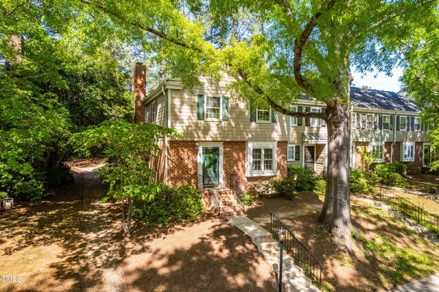 3029 Wycliff Rd, Raleigh, NC 27607 - view of front of house with brick siding and a chimney