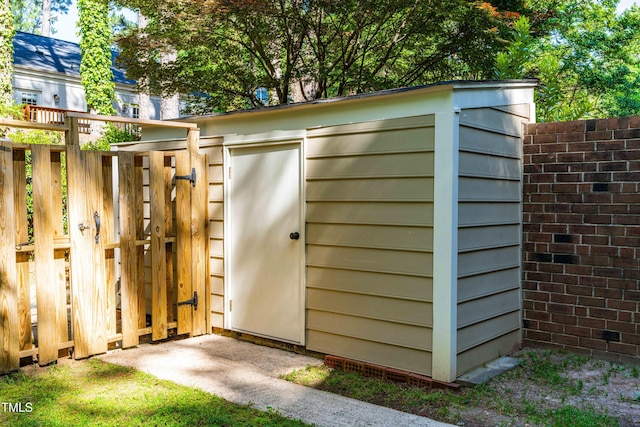 view of outbuilding with fence and an outdoor structure