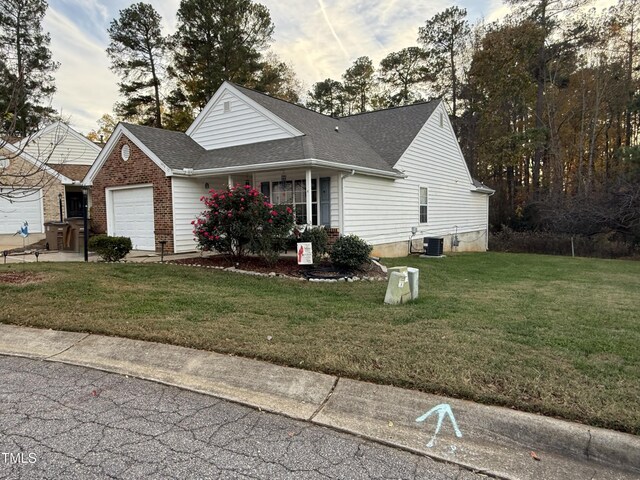 1454-17 Cimarron Pkwy, Wake Forest, NC 27587 - view of front of property with an attached garage, a shingled roof, central air condition unit, and a front yard
