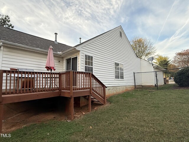 1454-17 Cimarron Pkwy, Wake Forest, NC 27587 - rear view of property featuring a yard, fence, a wooden deck, and roof with shingles