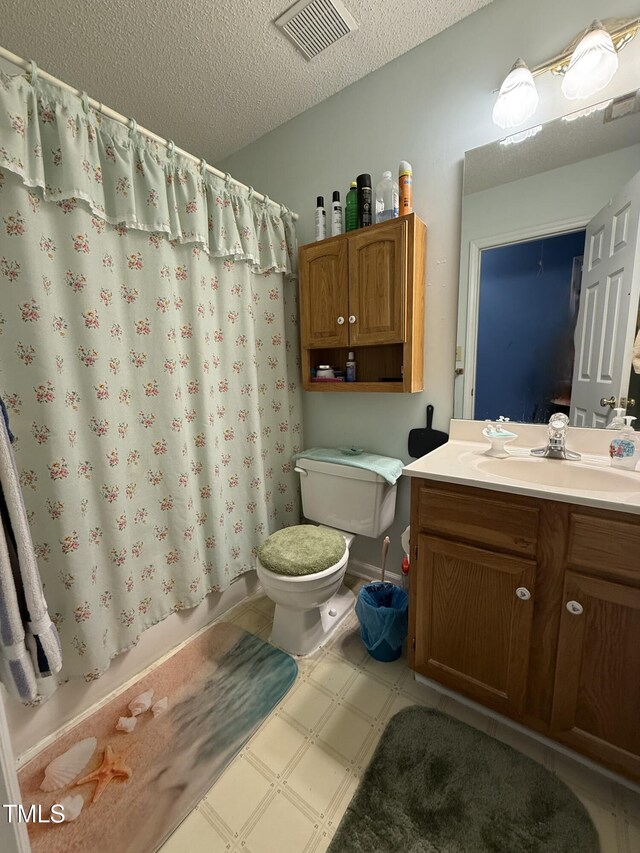 1454-17 Cimarron Pkwy, Wake Forest, NC 27587 - full bath with vanity, toilet, tile patterned floors, a textured ceiling, and visible vents