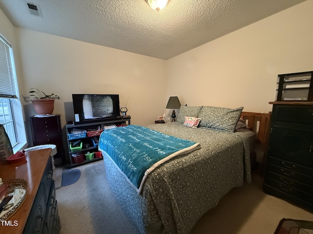 1454-17 Cimarron Pkwy, Wake Forest, NC 27587 - bedroom featuring visible vents, carpet flooring, and a textured ceiling