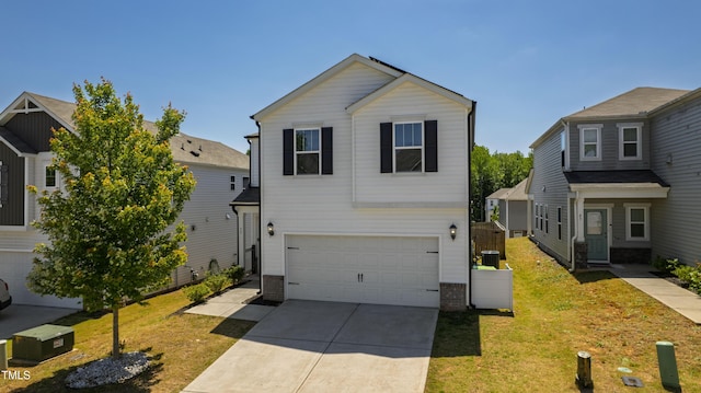 traditional home featuring an attached garage, driveway, and a front yard