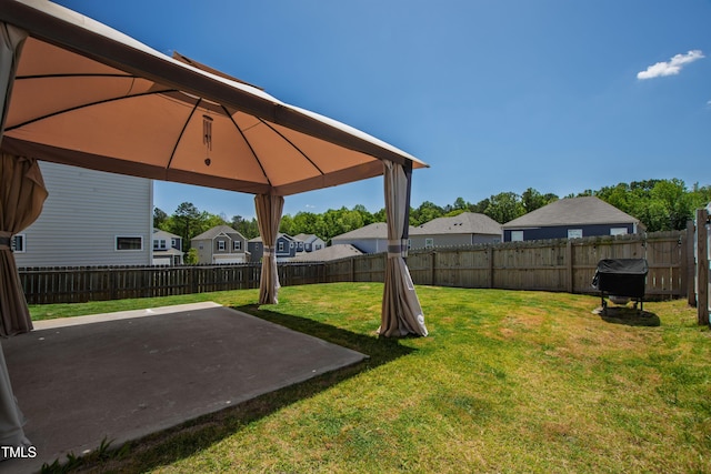 view of yard with a gazebo, a fenced backyard, a patio area, and a residential view