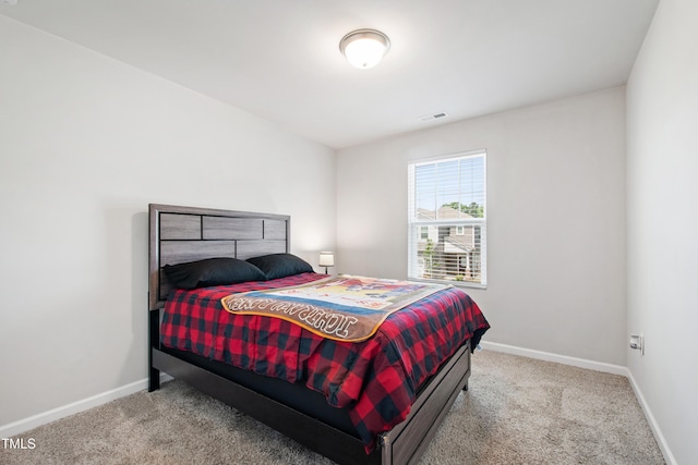 carpeted bedroom with visible vents and baseboards