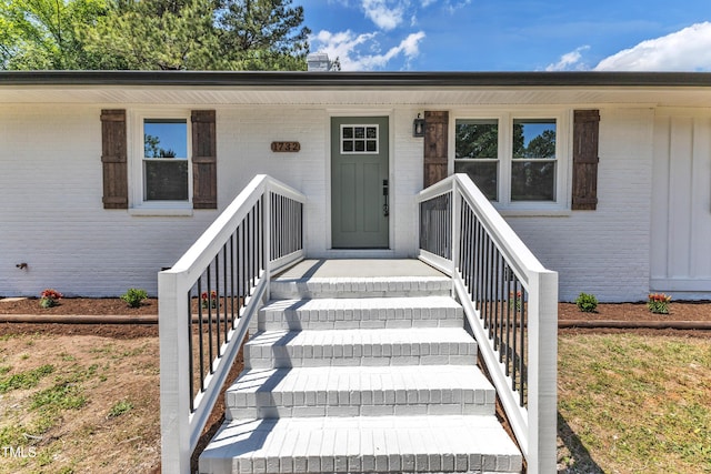property entrance with brick siding