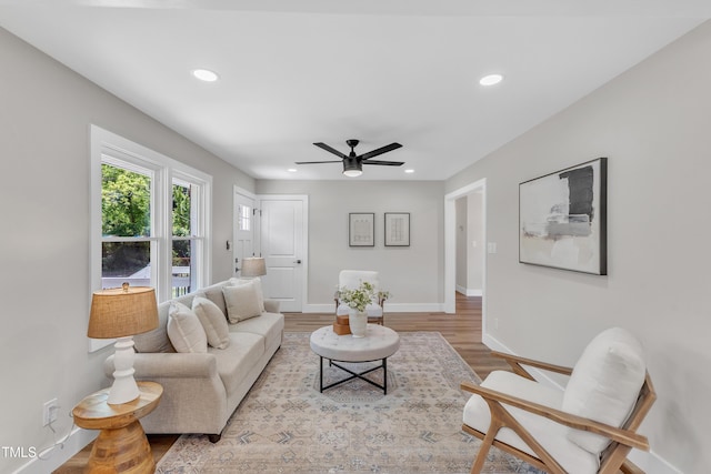 living room featuring recessed lighting, baseboards, ceiling fan, and wood finished floors
